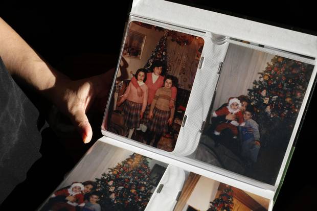Merell Awad shows family photos from her childhood during Christmas at home in Syria.