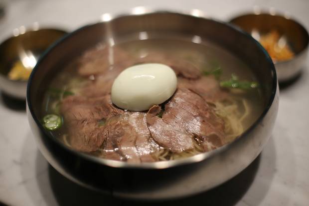Pyongyang naengmyeon is served at Mr. Yim's Seoul restaurant House of Peace. The cold dish is made from buckwheat noodles and boiled beef, typically served with a boiled egg on top.