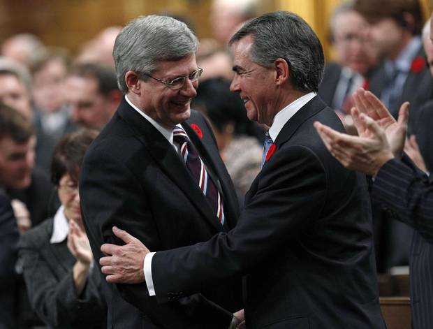 Prime minister Stephen Harper shakes hands with environment minister Jim Prentice after Mr. Prentice announced his resignation on Nov. 4, 2010.