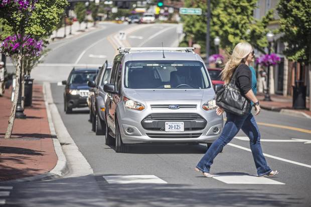 A Ford Transit approaches an intersection, part of a Virginia Tech study of how pedestrians will interact with autonomous vehicles.