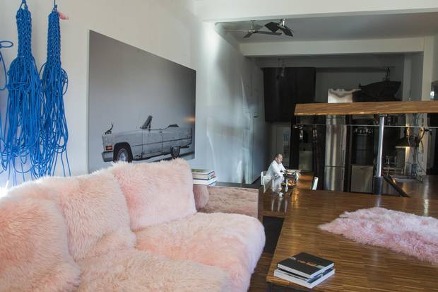 Claude Cormier favourite room is both his living room with it's chrome and pink fluffy couch which leads to his hydraulic kitchen that can close, become a table or a ramp in his home in Montreal, Quebec November 10, 2017.