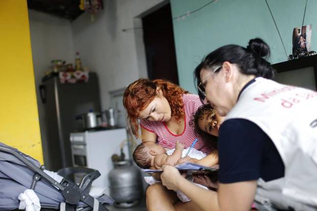 Angelica Porto de Oliveira holds her baby Ana Beatriz while she is examined by a researcher from Brazil's Ministry of Health in Joao Pessoa. Ana Beatriz was born healthy two months ago, in a neighbourhood with a surge in congenital Zika cases. The ministry, working with the U.S. Centers for Disease Control, this week launched a study of why some babies are affected and others not.