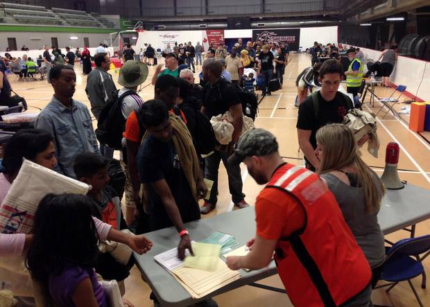 Evacuees from Fort McMurray, Alta., line up to register at an evacuee reception centre in nearby Anzac, Alta., on Wednesday.