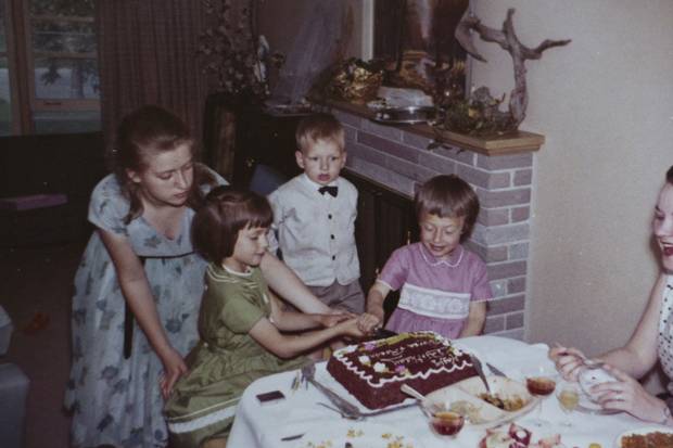 A childhood photo shows Rosanne and Theresa Luckevich – in green and pink dresses, respectively – celebrating their shared birthday.