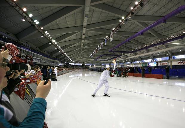 Former Olympian and medalist, long track speed skater Susan Auch carried the Olympic torch while skating the speed skating rink at Calgary's Olympic Oval during the torch relay ahead of the 2010 Vancouver Games.