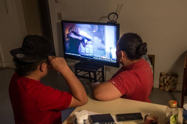 Fernando and his aunt watch TV. In order to release Fernando from a youth detention centre, his aunt had to identify herself to the Department of Homeland Security, meaning authorities will know where to find her if she is deported.