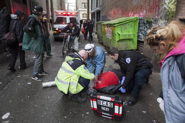First responders help an overdose victim in a Downtown Eastside alley.