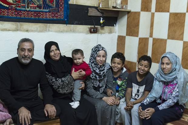 Ahmad, Muna and their five children in an apartment in Amman. The family escaped the conflict in Syria in 2013 and currently rely on monthly cash assistance.
