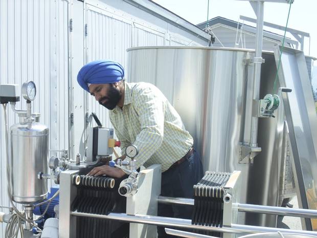 Karnail Sidhu filters wine at his winery, Kalala, in Kelowna, B.C. Kalala has steadily expanded since its establishment in 2006, with its wines now available across British Columbia as well as going overseas to China and India. Sidhu emphasizes the importance of using high-quality, organic ingredients in his wines.