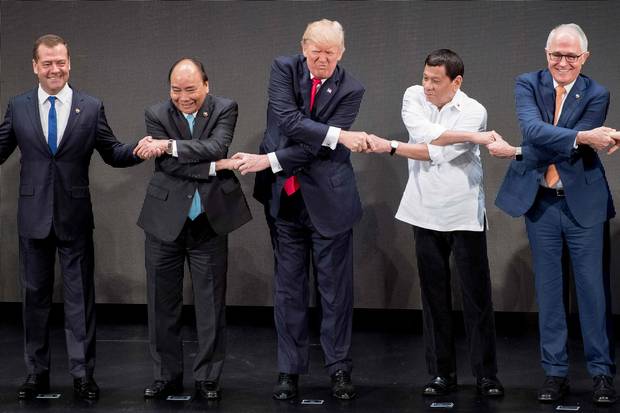 Nov. 13, 2017: Mr. Trump, middle, joins hands with world leaders for a group photo at the opening ceremony of the ASEAN summit in Manila. So far, Mr. Trump’s counterparts abroad have found ways to restrain Mr. Trump’s impulses, or to carry on despite them.