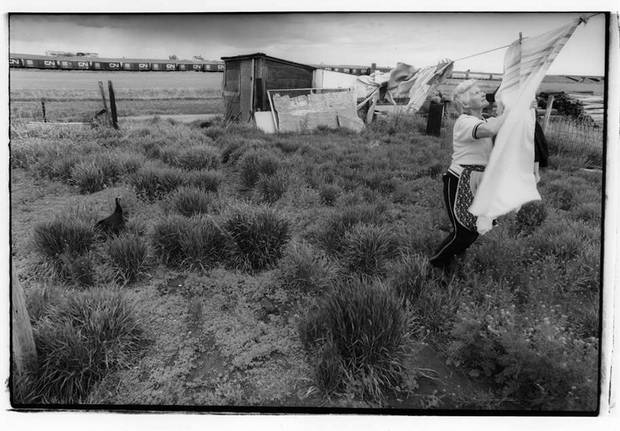Laundry Day, Moose Jaw, Sask., 1990. I loved roaming the countryside looking for pictures of daily life. I felt there was extraordinary in the ordinary as simple scenes played out before me. It was important to include subtle nuances like the turkey in the grass to balance an image like this one. Canadian iconography like railway cars were often there to enhance horizon lines.