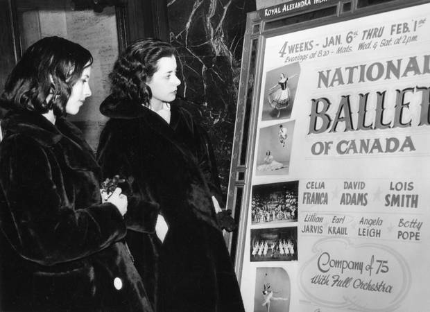 NATIONAL BALLET OF CANADA -- Georgina Parkinson and Hylde Zinkin look over National Ballet of Canada lobby poster advertising performances at the Royal Alexandra Theatre in Toronto, January 1958.