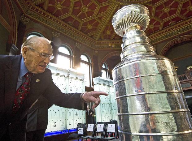 Johnny Bower looks for his name on the Stanley Cup after The Hockey Hall of Fame officially unveiled the ‘Esso Great Wall’ as home to the Stanley Cup, all major NHL trophies in Toronto in 2012.