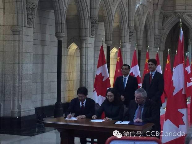 Tianzhou Deng, bottom left, at a signing ceremony with Chinese Premier Li Keqiang and Prime Minister Justin Trudeau behind.