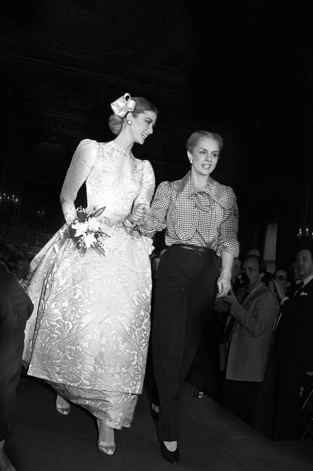 Herrera accompanies a model on the runway during the finale of her ready-to-wear fall collection in 1981 in New York.