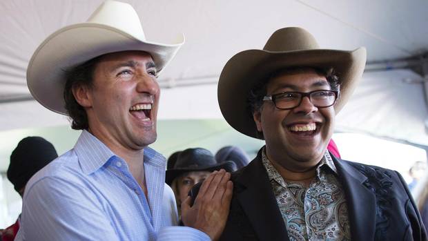 Liberal Leader Justin Trudeau shares a laugh with Mayor Naheed Nenshi at a Stampede breakfast in Calgary on July 7, 2013.