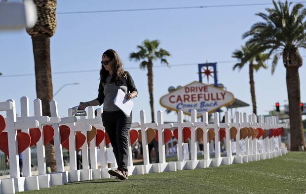 Sherri Camperchioli helps set up some of the crosses that arrived in Las Vegas today to honour the victims of the mass shooting.