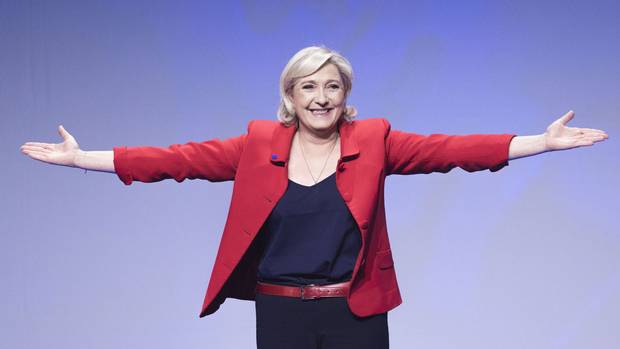 Marine Le Pen gestures as she arrives for a campaign meeting in Paris on April 17, 2017.