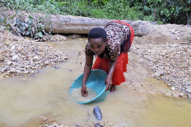 Bibicha Sanao pans for gold at a small mining site near the village of Metale in Ituri province, Democratic Republic of Congo. Small-scale mining is a huge source of income in many African countries, but female miners face widespread discrimination and cultural taboos.