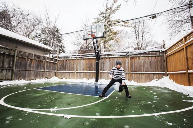 Leo Schofield-Fitzpatrick plays basketball in the backyard of his Parkdale home in Toronto on February 12, 2017.