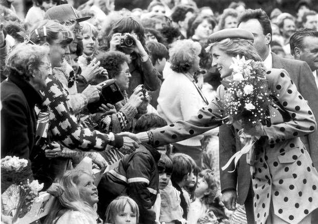 Diana, The Princess of Wales shakes hands with a girl in the crowd at the Legislature Buildings in Victoria, B.C.