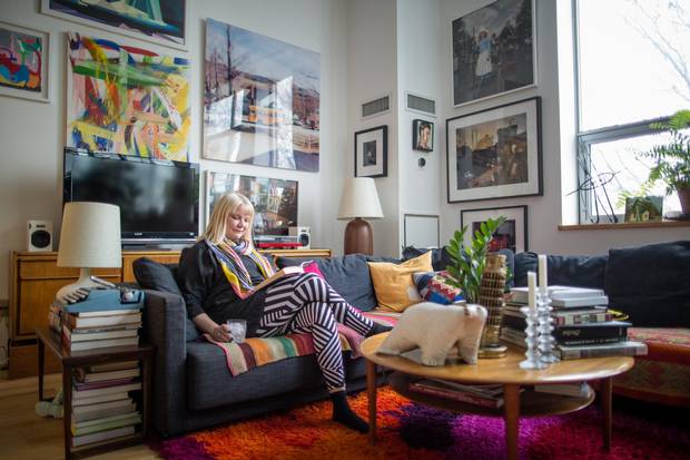Sarah Keenleyside enjoys the living room of her loft appartment in Toronto's Kensington Market.