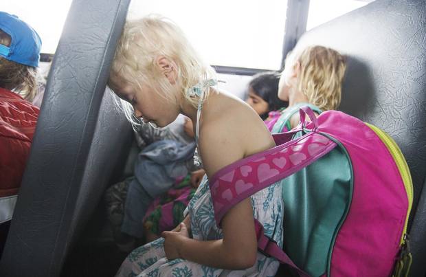 Billie Page dozes off as she rides the school bus to the ferry dock on her way home.