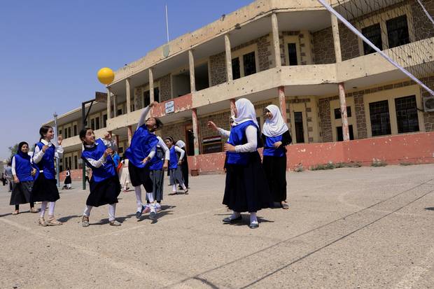 Iraqi girls play in a yard of a school in Mosul, Iraq July 18, 2017.