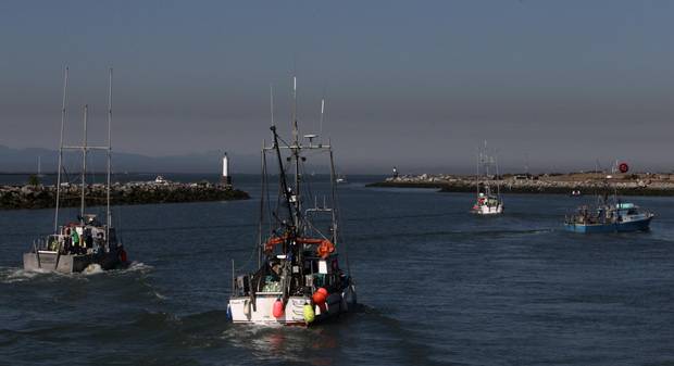 Commercial fishing boats head out on the Fraser River from Steveston Harbour in Richmond, B.C., in 2010. Many fishermen are afraid to publicly criticize the system for fear they’ll be blacklisted from leasing quotas.