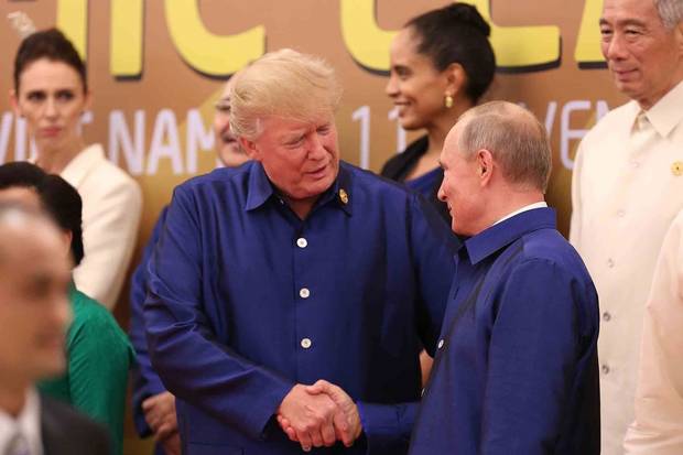 Danang, Vietnam, Nov. 10: U.S. President Donald Trump shakes hands with Russia's President Vladimir Putin as they pose for a group photo ahead of the Asia-Pacific Economic Co-operation summit leaders gala dinner.