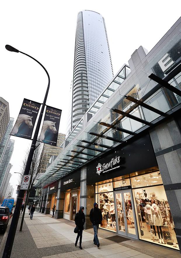Pedestrians walk past a store situated in the retail space outside the Trump International Tower and Hotel in Vancouver.