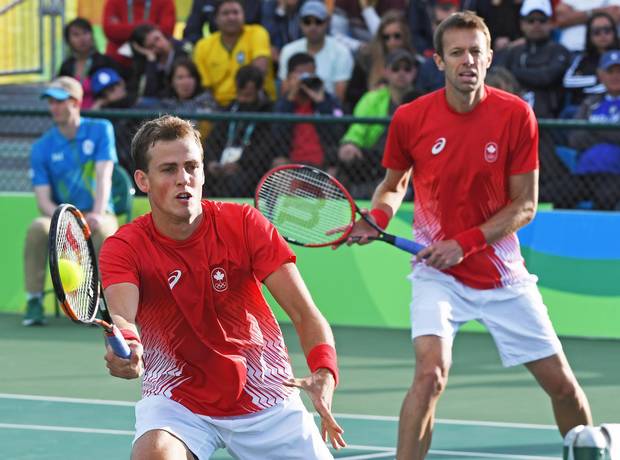 Canada's Vasek Pospisil, left, and teammate Daniel Nestor returns to Spain's Marc Lopez and Rafael Nadal in men's doubles tennis semifinal action at the 2016 Olympic Games in Rio de Janeiro, Brazil on Thursday, Aug. 11, 2016.