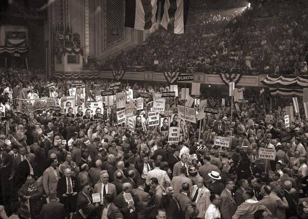 In this June 23, 1948, file photo, delegates with posters and state signs crowd down the center aisle at Convention Hall in Philadelphia during a demonstration for Gov. Thomas E. Dewey after his name was placed in nomination during the Republican National Convention. Dewey won the Republican presidential nomination on the third ballot of a contested convention in Philadelphia. Months later, he lost the general election to Democratic incumbent Harry S. Truman.