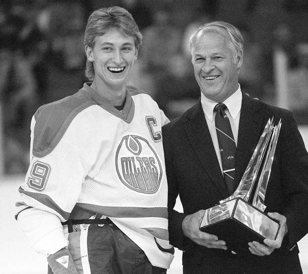 Gretzky being presented the Emery Edge award by former NHL great Gordie Howe in 1984. The trophy was given to the player with the best plus-minus stats in the league. 