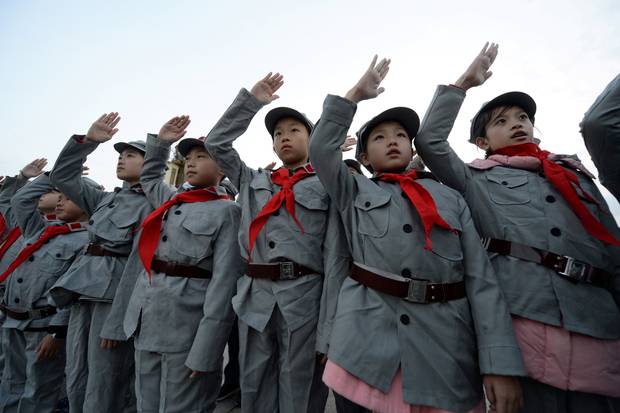 Beijing: Primary school students dressed in replica red army uniforms attend a flag-raising ceremony at Tiananmen Square.