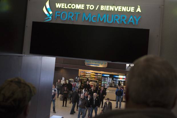 Travellers head for the baggage-claim area at the Fort McMurray airport on April 5, 2015.