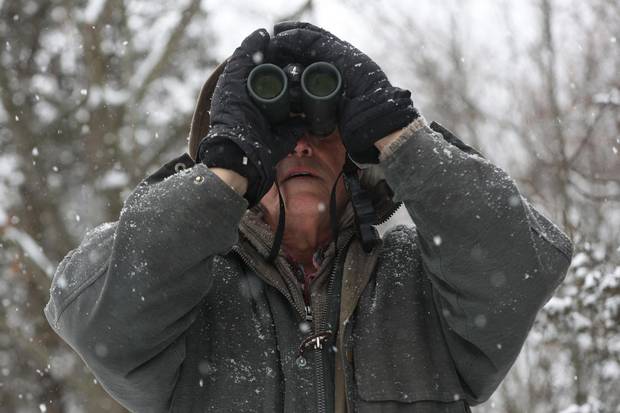 Michael Runtz looks for birds on his trail behind his home in Seeley's Bay, Ont., on Friday Dec. 22, 2017.