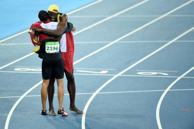 Usain Bolt of Jamaica, first place, and Andre De Grasse of Canada, third, celebrate after the Men's 100 meter final on Day 9.