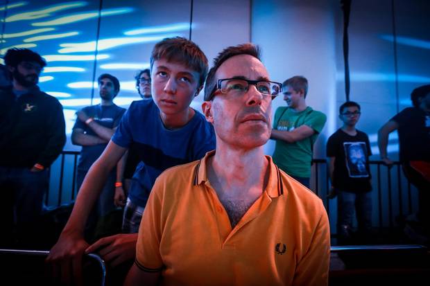 A large room full of fans including Sascha Houpt and his mystified dad Simon watch as two teams, Immortals from Brazil, and Cloud9 from North America, play Counter Strike Global Offensive at the Northern Arena E-sports Championship Toronto LAN Finals on September 4, 2016.