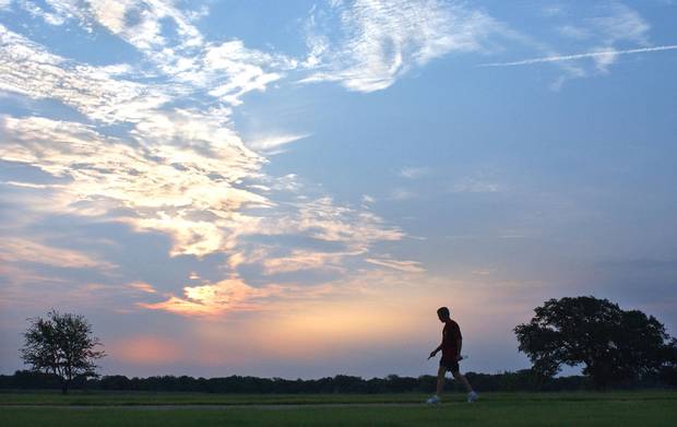 Aug. 9, 2002: U.S. president George W. Bush is silhouetted against an early morning sky after a run at his ranch in Crawford, Texas on August 9, 2002.