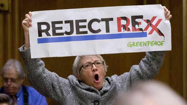A protester yells during the confirmation hearing for Secretary of State-designate Rex Tillerson before the Senate Foreign Relations Committee, Wednesday, Jan. 11, 2017, on Capitol Hill in Washington.