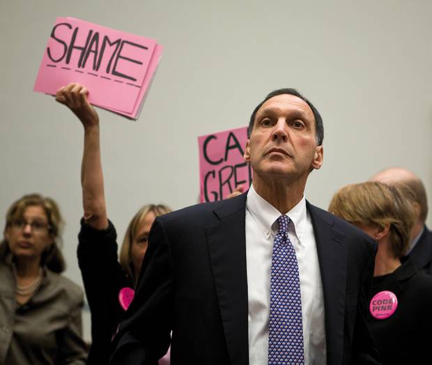 Richard S. Fuld Jr., Chairman and CEO of Lehman Brothers investment bank testifies before the House Oversight and Government Reform Committee on Capitol Hill, as protesters from “Code Pink” wave signs reading “Shame”. Code Pink is a women- initiated grassroots peace and social justice movement. Washington DC, USA, 2008. Lehman Brothers filed for Chapter 11 bankruptcy protection on 15 September, 2008. The filing remains the largest bankruptcy filing in U.S. history, with Lehman holding over $600 billion in assets.