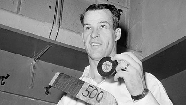 Gordie Howe of the Detroit Red Wings poses with the hockey puck in the dressing room at Madison Square Garden after he scored the 500th goal of his National Hockey League career in New York City, March 14, 1962. The man known as Mr. Hockey has died. The Detroit Red Wings say Gordie Howe has died at age 88.