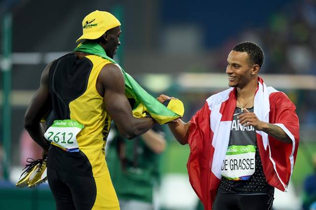 RIO DE JANEIRO, BRAZIL - AUGUST 14: Usain Bolt of Jamaica celebrates winning the Men's 100 meter final with Andre De Grasse of Canada on Day 9 of the Rio 2016 Olympic Games at the Olympic Stadium on August 14, 2016 in Rio de Janeiro, Brazil. (Photo by Matthias Hangst/Getty Images)