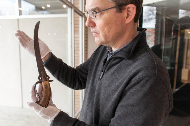 Dennis Oomen, curator the City of Penticton Museum, holds a Spanish sword that was discovered on the grounds of the O'Keefe Ranch in the North Okanagan near Vernon, B.C.