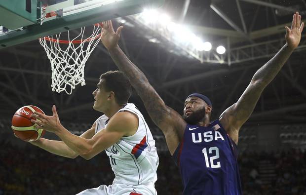 Nemanja Nedovic of Serbia and Demarcus Cousins of the USA compete. The U.S. routed Serbia 96-66 to win a third straight gold medal in men's basketball..