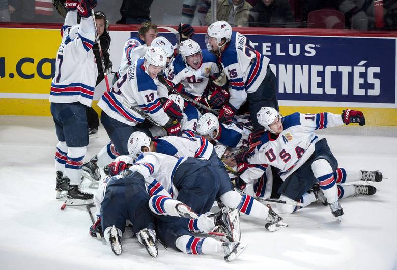 Members of the United States team celebrate a goal by Troy Terry in the shootout to beat Russia 4-3 IIHF World Junior Championship semifinals hockey action Wednesday, January 4, 2017 in Montreal.