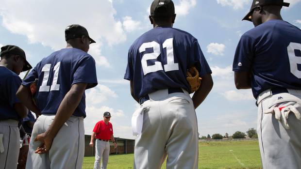 Coach Garth Iorg speaks to baseball players at the MLB African Elite camp.