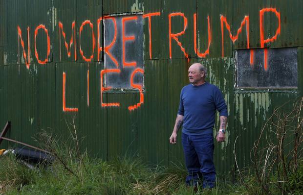 Scottish fisherman Michael Forbes poses for a photograph by the side of a building on his property near Aberdeen in 2010.