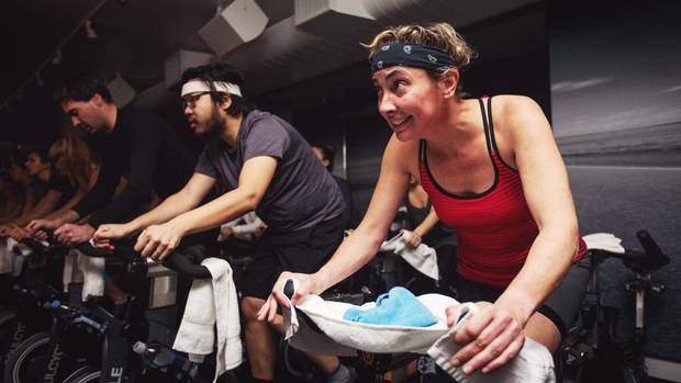 From left, Globe writers Dave McGinn, Clifford Lee and Trish McAlaster suffer through a workout at the new SoulCycle studio in Toronto on Tuesday. February 21.